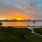 Sunset over Knysna Lagoon, South Africa, with sailboats and golden light on the water